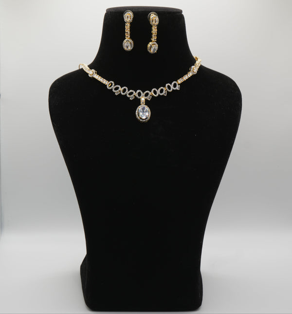 Jewelry set with necklace and earrings on a black mannequin bust against a white background