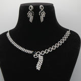 Black VVS necklace and earrings set on a black mannequin bust with a gray background