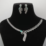 Close up of Mint diamond necklace and earrings on a black velvet bust with a gray background