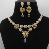 Close up of Royal blue Jewelry set with necklace and earrings on a black mannequin bust against a white background