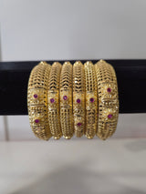 Banarasi Ruby Filigree Kada Set — set of 6 thick gold filigree kada bangles with intricate cut-work and ruby pink stone accents