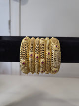 Banarasi Ruby Filigree Kada Set — set of 6 thick gold filigree kada bangles with intricate cut-work and ruby pink stone accents
