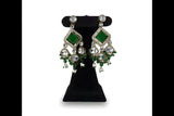 Emerald green kundan polki choker necklace set with matching earrings and tikka on black velvet stand full view
