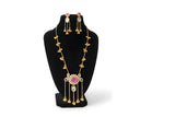 Kashmiri ruby polki long pendant necklace set with matching earrings full view on black velvet bust