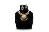 Antique gold meenakari fan pendant pearl necklace set with earrings and gold ball drops on black display stand