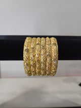 Nakshi Paisley Engraved Kada Set — set of 6 gold kada bangles with hand-engraved floral and paisley motifs and diamond-cut detailing