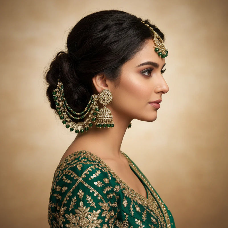 South Asian bride wearing green kundan bahubali jhumka earrings with sahara chain and tikka green lehenga Jewellery by Aman