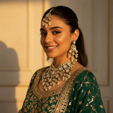 South Asian bride wearing gold kundan polki choker set with pearl drops tikka and chandelier earrings green lehenga Jewellery by Aman