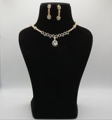 Jewelry set with necklace and earrings on a black mannequin bust against a white background