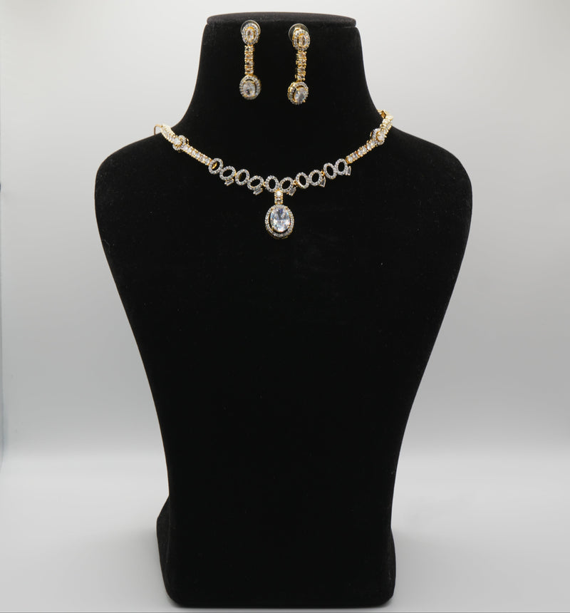 Jewelry set with necklace and earrings on a black mannequin bust against a white background