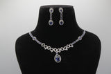 Blue Jewelry set with necklace and earrings on a black mannequin bust close up against a gray background