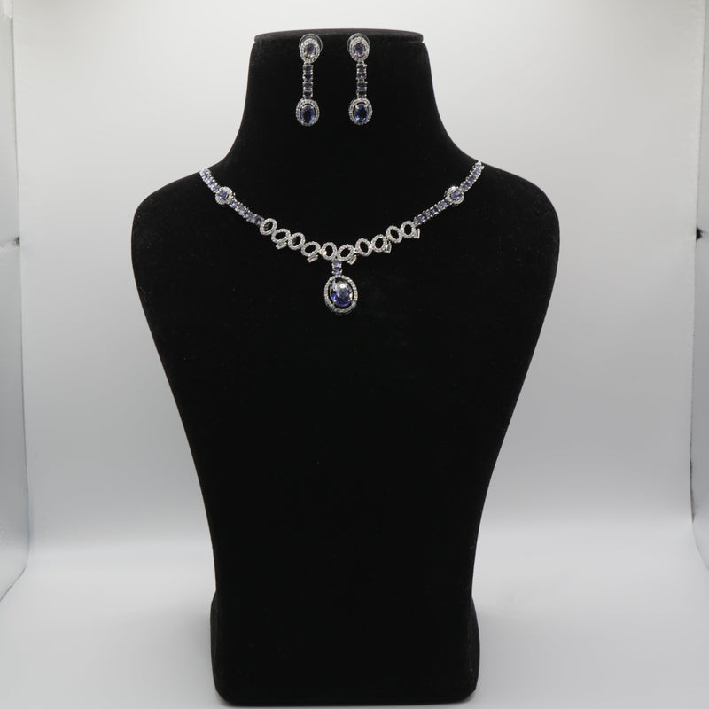 Blue Jewelry set including necklace and earrings on a black mannequin bust against a white background