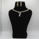 Pearl necklace and earrings set on a black mannequin bust against a white background