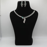 Mint diamond necklace and earrings on a black velvet bust with a gray background