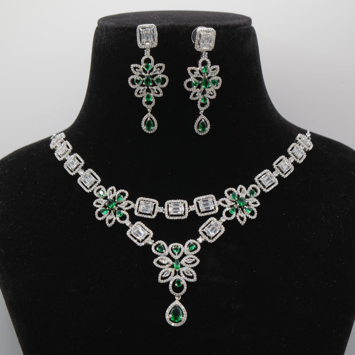 Close up of Panna Emerald Regal Pendant - VVS American Diamond Collection - Jewellery by Aman on a black velvet bust