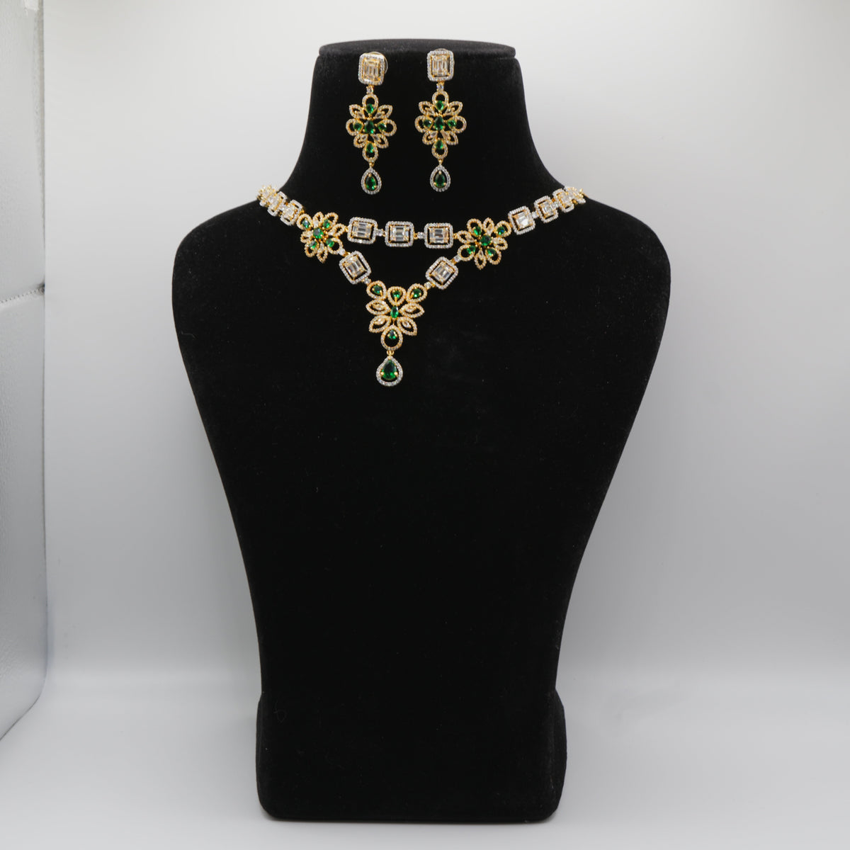 Emerald Green Jewelry set with necklace and earrings on a black mannequin bust against a white background