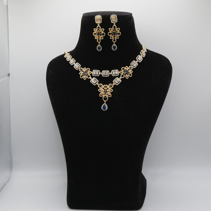 Royal blue Jewelry set with necklace and earrings on a black mannequin bust against a white background