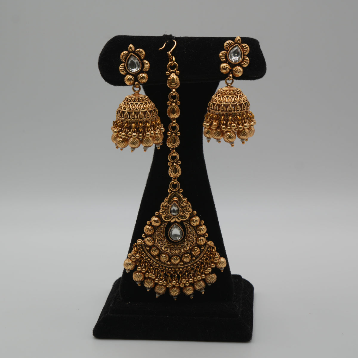 Ananya Kundan Centrepiece Choker Set — gold plated centrepiece pendant choker with clear kundan stones, pearl strand sides and gold bead drops, matching jhumka earrings and large teardrop maang tikka