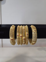 Banarasi Ruby Filigree Kada Set — set of 6 thick gold filigree kada bangles with intricate cut-work and ruby pink stone accents
