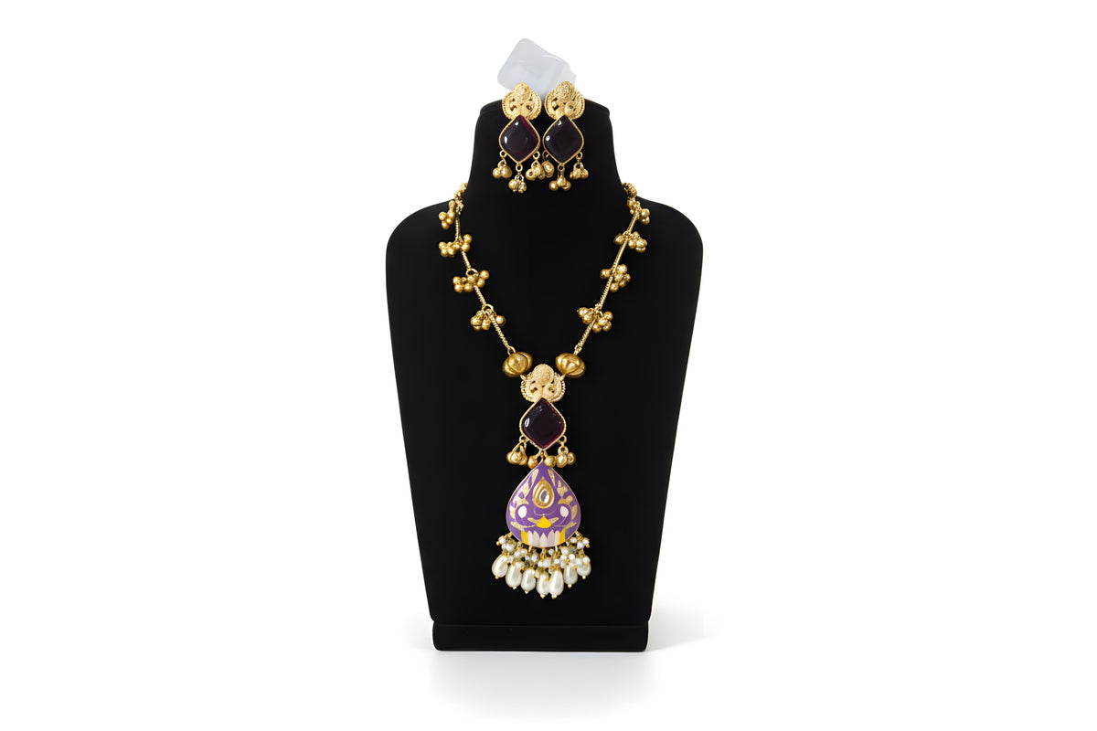 Close up of purple meenakari pendant with dark green stone earrings
