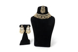 Gold Polki Chandbali Necklace Earrings and Tikka Set on display