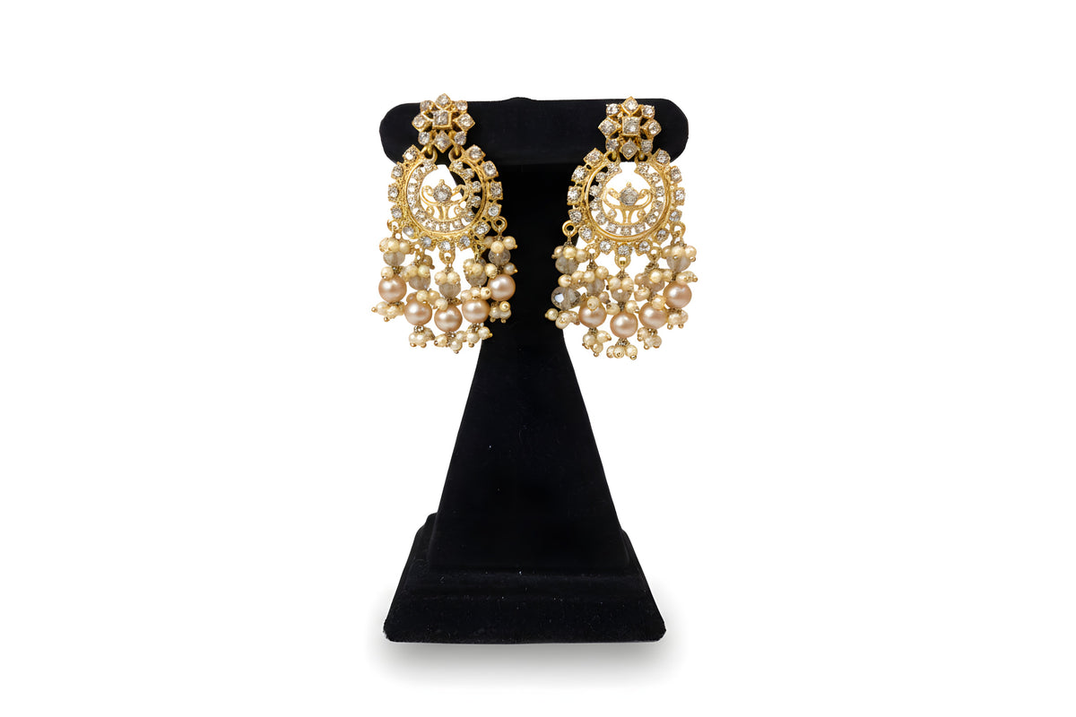 Close up of Gold Polki Chandbali Earrings with champagne crystal and pearl drops