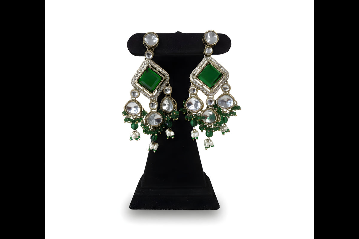Emerald green kundan polki choker necklace set with matching earrings and tikka on black velvet stand full view