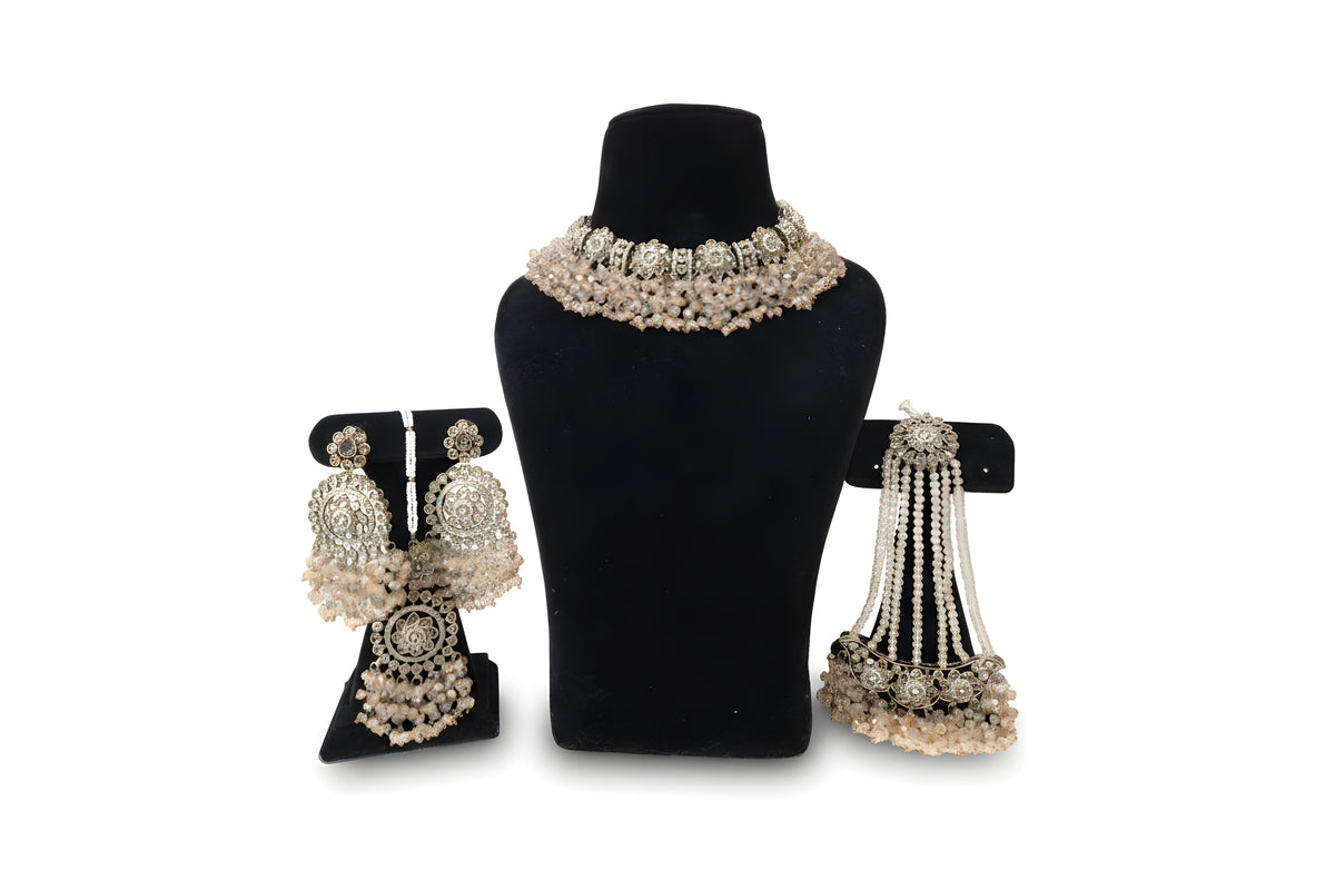 Blush pink polki wedding set full view showing choker necklace chandbali earrings tikka and passa on black velvet display