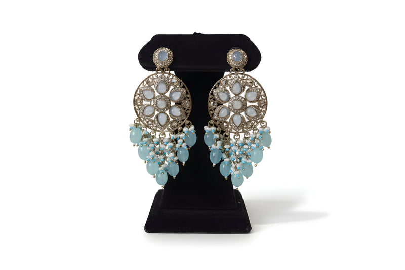 Baby blue mint polki chandbali earrings with aqua and white bead drops on black velvet stand