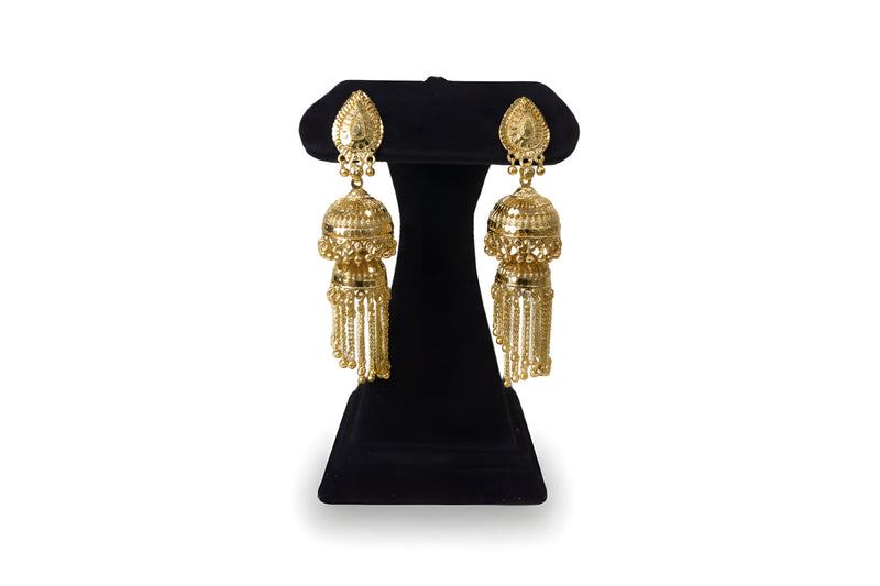 Gold plated double jhumka chain tassel earrings on black velvet stand showing full filigree detail and gold chain drops