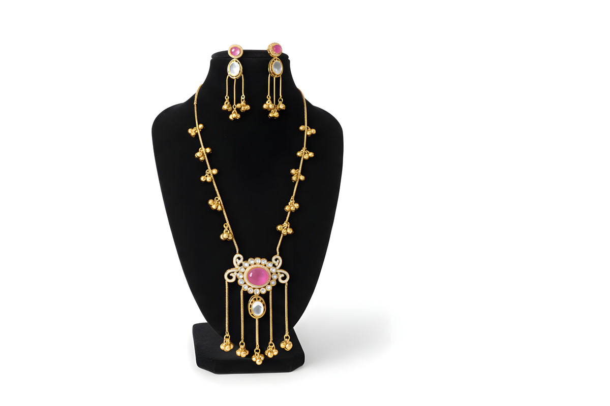 Kashmiri ruby polki long pendant necklace set with matching earrings full view on black velvet bust