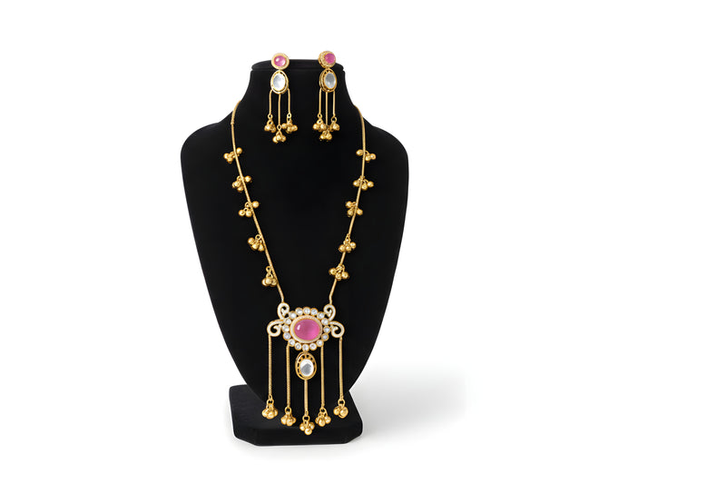 Kashmiri ruby polki long pendant necklace set with matching earrings full view on black velvet bust