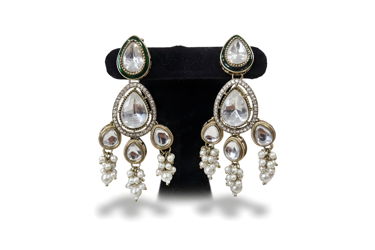 White pearl kundan chandelier earrings close up with large polki teardrop stone CZ halo and pearl cluster drops Jewellery by Aman