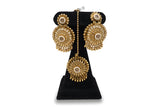 Antique gold circular chandbali earrings and tikka close up with CZ pearl centre and gold ball drops Jewellery by Aman