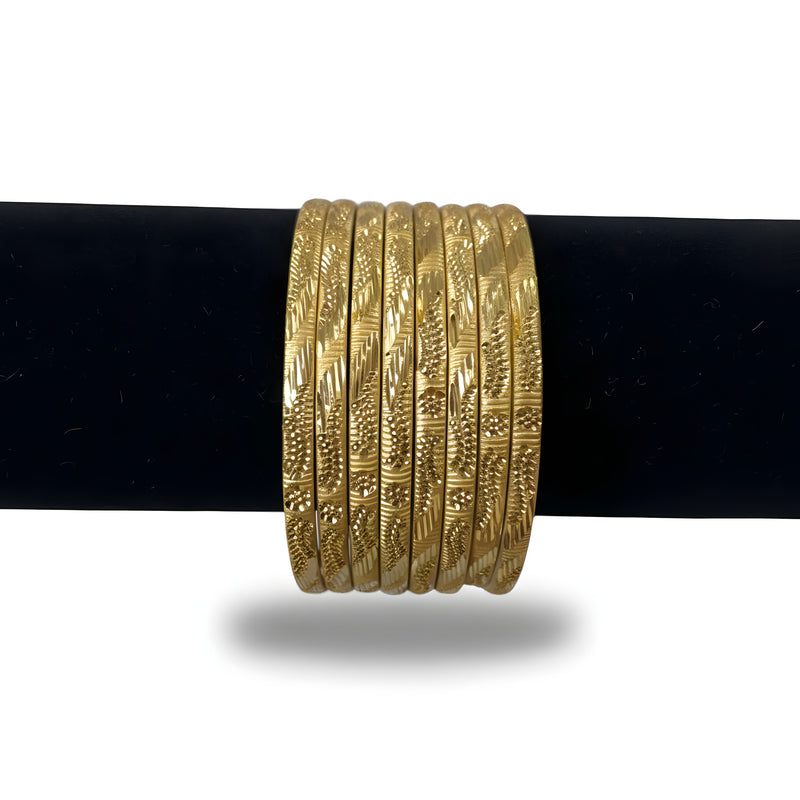 Gold plated diamond cut engraved bangles set of 8 with diagonal chevron leaf pattern on black stand front view