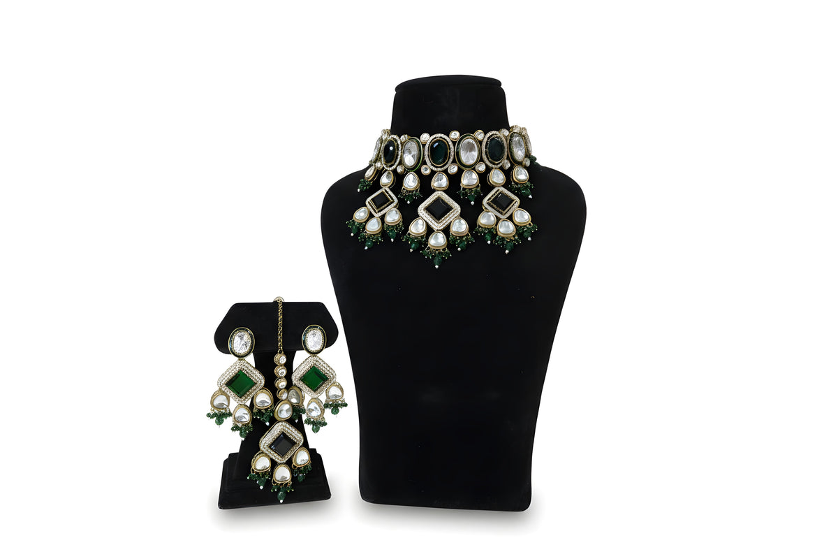 Close up emerald green kundan earrings and tikka with diamond CZ pave centre stone and crystal drops