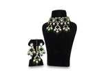 Close up emerald green kundan earrings and tikka with diamond CZ pave centre stone and crystal drops
