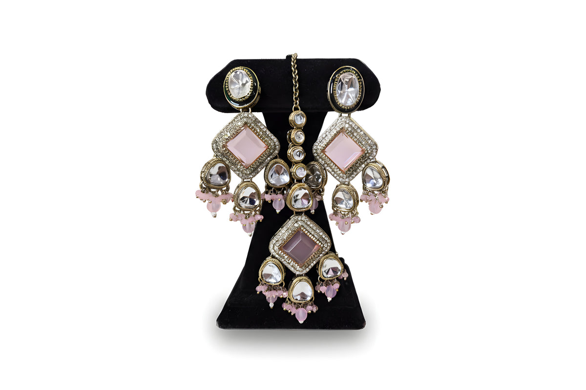 Close up blush pink kundan earrings and tikka with diamond CZ pave centre stone and pink crystal drops