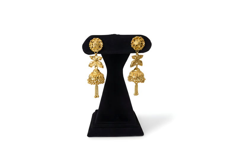 Gold plated peacock jhumka earrings with spread wings bird motif engraved dome bell and chain fringe drops