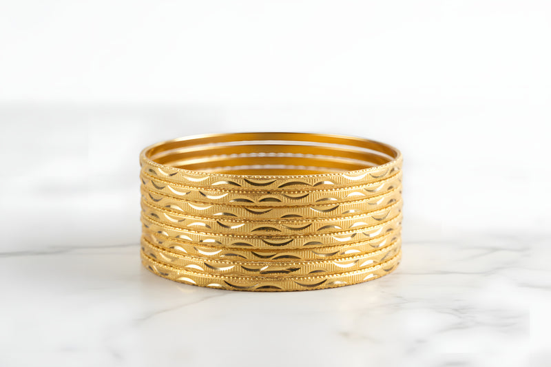 Gold plated cutwork lattice bangles set of 8 with diamond shaped openings and diamond cut textured borders front view