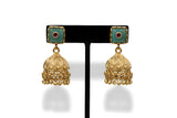 Close up gold plated jhumka earrings with mint green stone tops and ruby accents