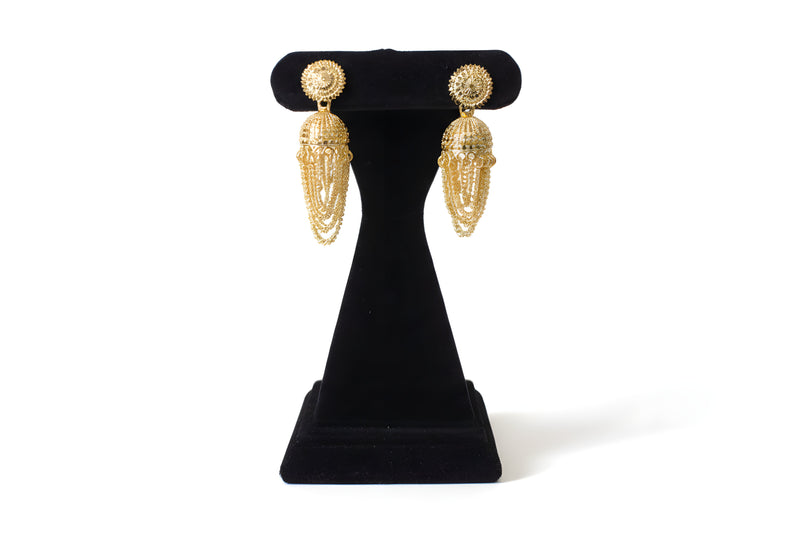 Gold plated jhumka earrings with cascading chain tassel drops on black display stand - Jewellery by Aman
