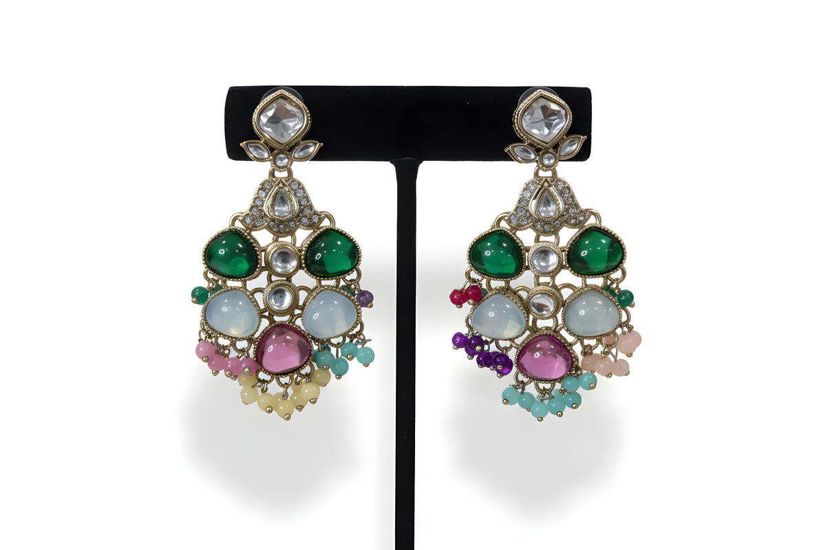 Close up of multicolour polki kundan chandbali earrings with emerald green pink and teal stones and bead drops