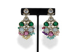 Close up of multicolour polki kundan chandbali earrings with emerald green pink and teal stones and bead drops