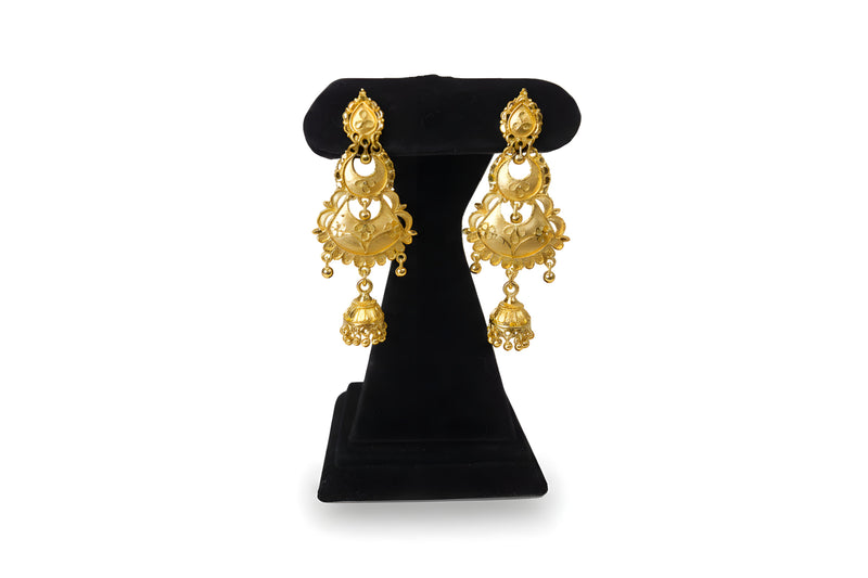 Gold plated three tier chandbali jhumka earrings with crescent moon and fan filigree drop on black display stand