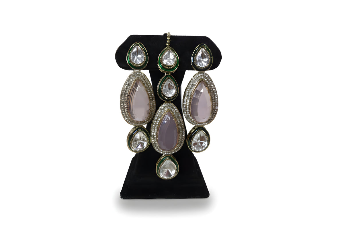 Close up of pink polki kundan long drop earrings with CZ halo and green enamel border