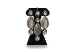 Close up of pink polki kundan long drop earrings with CZ halo and green enamel border