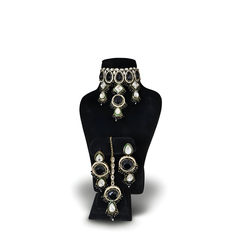 Jet black kundan wedding choker necklace set with long earrings on black display stand