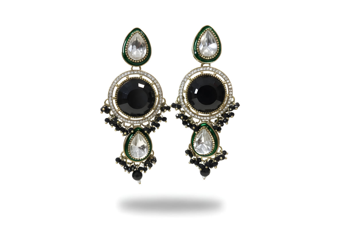 Close up of jet black kundan long drop earrings and tikka with green enamel and CZ halo