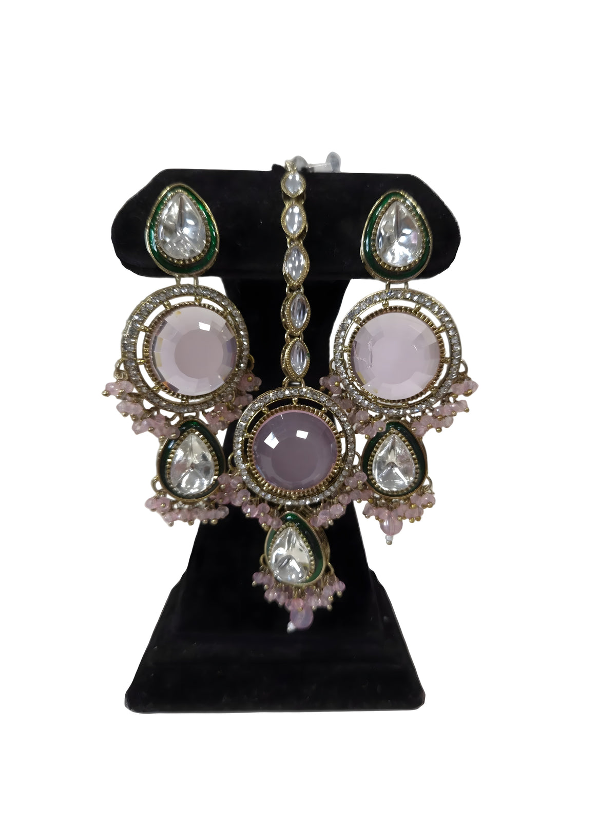 Close up of blush pink kundan long drop earrings and tikka with green enamel and pink crystal drops